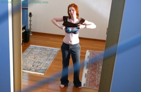 The all-natural redhead is captured on a hidden camera with its cute butchering poses over a nice ass.