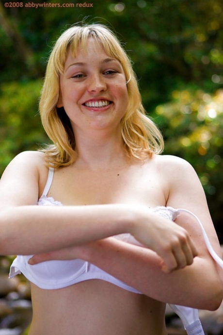 In front of camera: Busy blonde amateur Anneke removes her clothes to show off big natural tits.