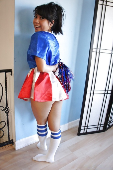 Asian young cheerleader May Lee dressed in an adorable uniform and socks.