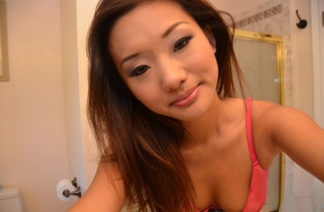 Taking selfies in the shower: Asian beauty Alina Li poses for a picture while taking self-posed selfies in the shower.