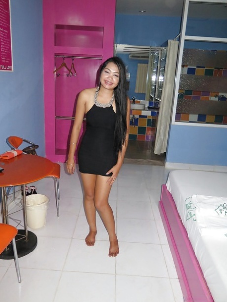 This photo features a young Thai barmaid showing off her newly-shaven Bangkok pussy.