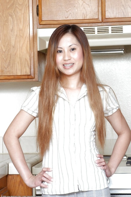 Small breasts are loose from a shirt in the kitchen of an Asian amateur, specifically Cristina.