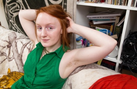 The amateur redhead Addie, displaying furry armpits and masturbating beaver.