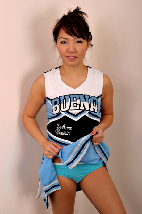 Amateur Asian solo girl sheds cheerleader uniform to bare tiny teen tits