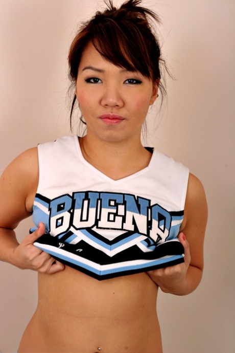 Amateur Asian solo girl sheds cheerleader uniform to bare tiny teen tits