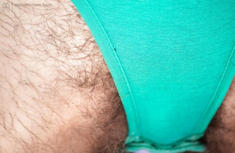 Shorts and panties are removed from an Australian first-timer to facilitate the diffusion of a cuddly orgasm.