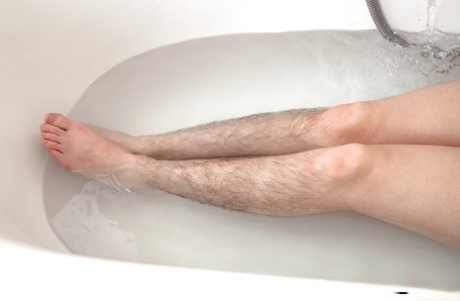Hirsute Mature Broad Displaying Hairy Legs And Tiny Tits In Bathtub