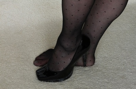 The elderly figure, Kathy Gilbert, is displaying impressive height by wearing stockings and high heels.