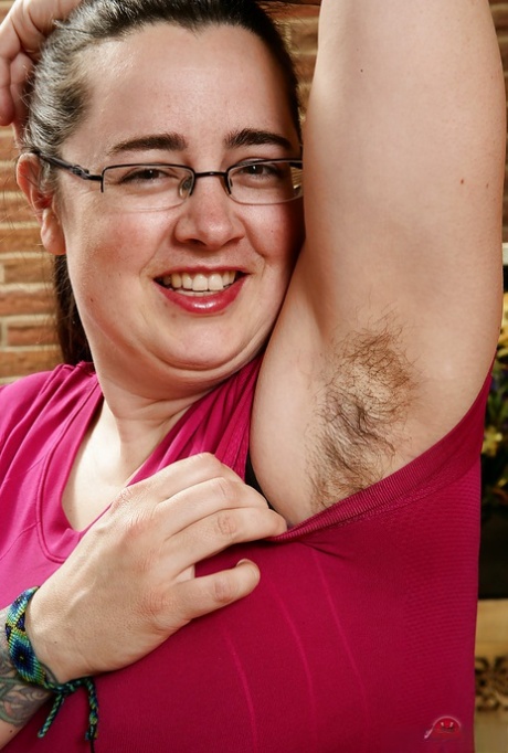 Mature fatty in glasses showing off hairy underarms and fleshy breasts