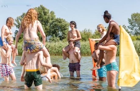 Amateur Europeans' naked girls and boys wrestle off the beach in front of their families.