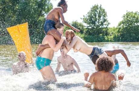 Unpermitted European girls and boys wrestle naked in the middle of the beach.