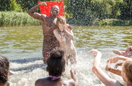 European girls and boys engage in a naked wrestling competition while basking at the beach.