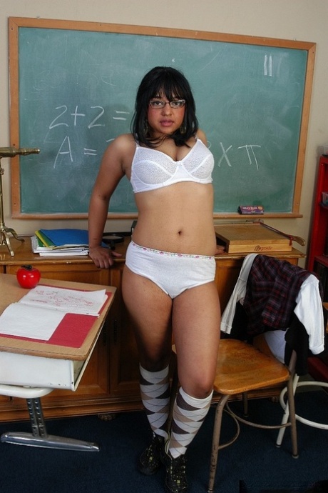 In school, Lily, a young girl with fatty skin, stripped down to her argyle clothing and glasses.