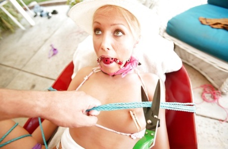 A gag in her mouth is performed on Diana Doll, the MILF molly, while she indulges in hardcore BDSM sexual activity.