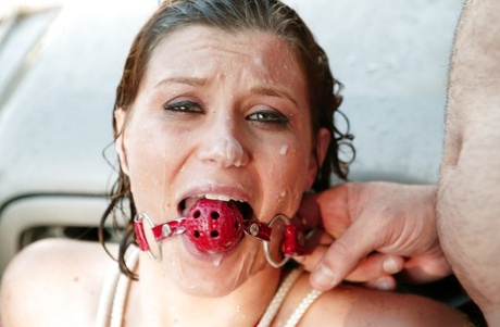 An outdoor bondage event sees Sara Stone perform hard blows while eating huge melons.