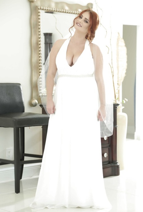 Lennox Luxe displaying large natural tits beneath a wedding dress for the chubby redhead.