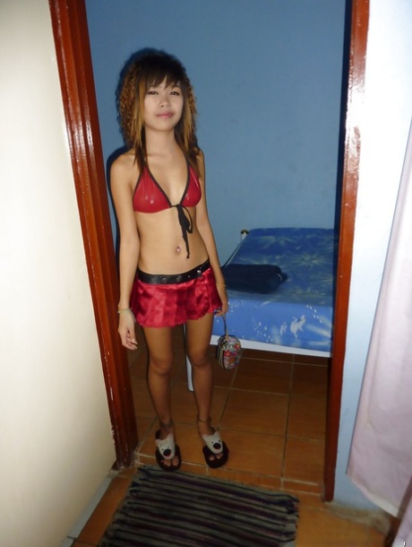 In bed, Ploy, a tiny Thai bar girl, displays tight ass and pussy.