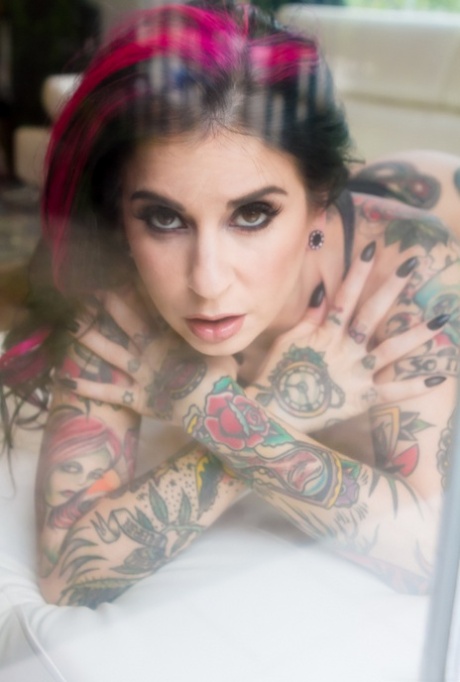 Heavily tattooed model Joanna Angel slips off her sensual black onesie