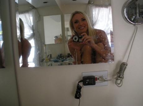 Playful blonde Addison Cain blows kisses and takes nude selfies in the mirror.