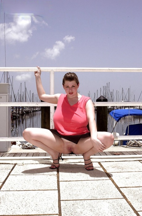 Offshore, Desirae is displaying her substantial breasts and full-length vagina on the boat dock.