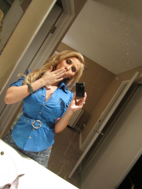 Busty blonde Madison Ivy taking mirror selfies while removing animal print bra