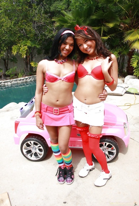 Asian lesbian teens reveal amazing butts and big boobs playing near a pool