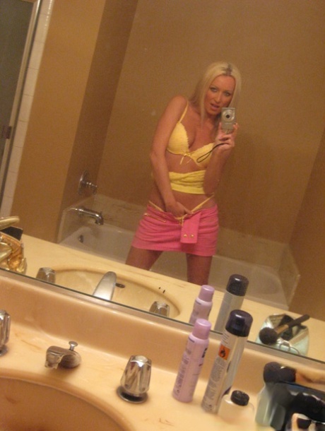 The bathroom selfies feature blonde amateur Diana Doll, who is naked.