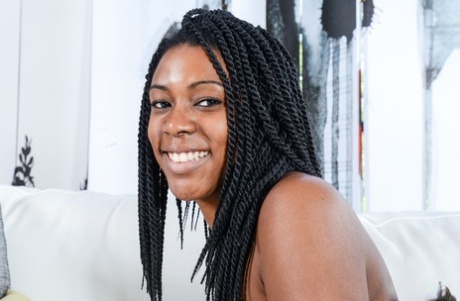 With a happy expression, Janelle Taylor showcases her hairy bush. She is also known as a black amateur.