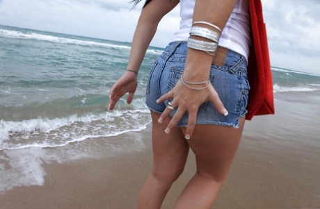 During her leisure time on the beach, Sasha's amateur girlfriend enjoys stripping and fingering.