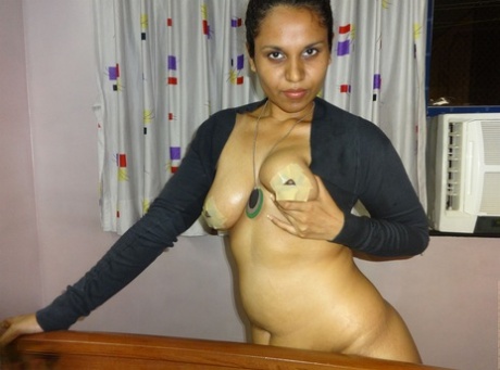 A chubby Indian female displays her ample breasts during a live webcam presentation.