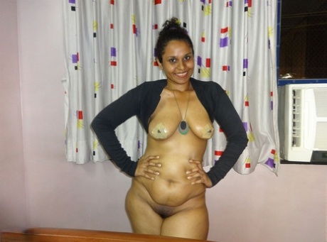 During a live webcam presentation, a plump Indian female displays her prominent breasts.