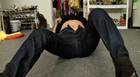 An Asian girl with horny features, taking off her skinny jeans and engaging in cuntillation.