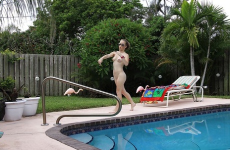 Amateur wrestler Madison Chandler stripping near the pool.