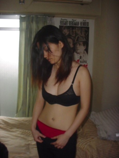 Seductive asian babe slipping off her clothes and showing off her big tits