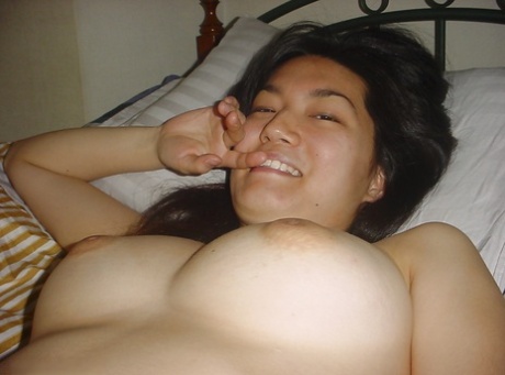 The hot Asian female flaunting her body and revealing big breasts.