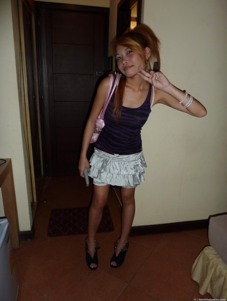 A charming Asian female in a mini skirt showering and enjoying her turn on.