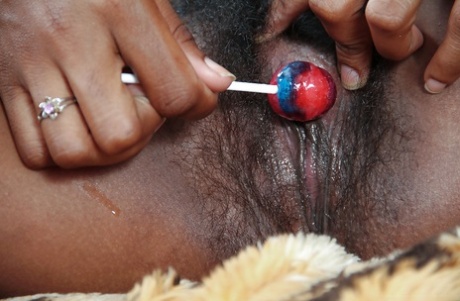 Seductive Ebony Teen Babe Masturbating Her Hairy Twat With A Lollipop