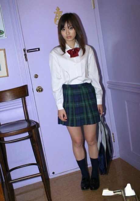 Pretty asian teen babe with tiny tits taking off her school uniform