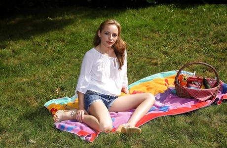 Outdoors, a dirty young woman playing with herself while stripping.