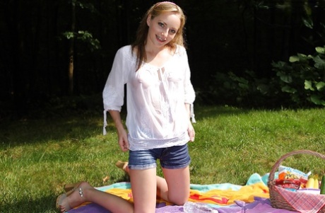 An unassuming girl with no experience stripping and playing with herself in an outdoor setting.