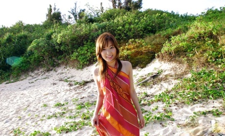 A stunningly attractive Asian female, Yua Aida flaunts her curves while out in the sun.