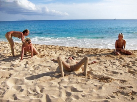 Teenagers in full-figured attire, sporting sunglasses, enjoying the beach.