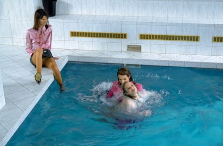Fully clothed fetish ladies having some wet fun in the pool Pool photo #7