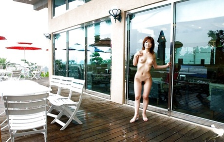 A stunningly attractive Asian female, An Nanba is displaying her desirable physique in an outdoor setting.