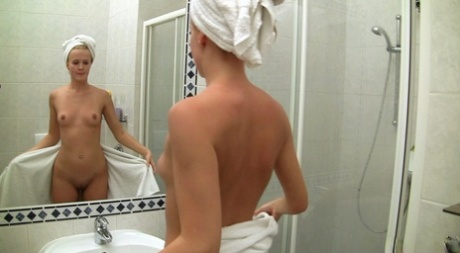 A stunning blonde and sabre-haired person with freckles in a tiny shower, Andrea Francis.