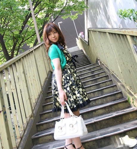 Out in the open: Smiley asian girl flashes with her petite breasts and sweet feet.