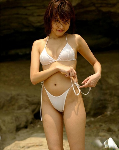 Intimate the Asian Babe with attractive jugs and pose in bikini outdoor attire.