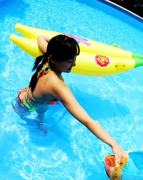 The sultry Asian lady enjoys her time in the pool by flaunting her big jugs.