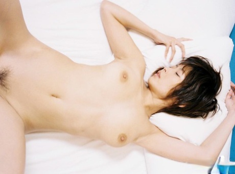 The nude: Asian hot-stylist Nana Natsume poses on the bed.