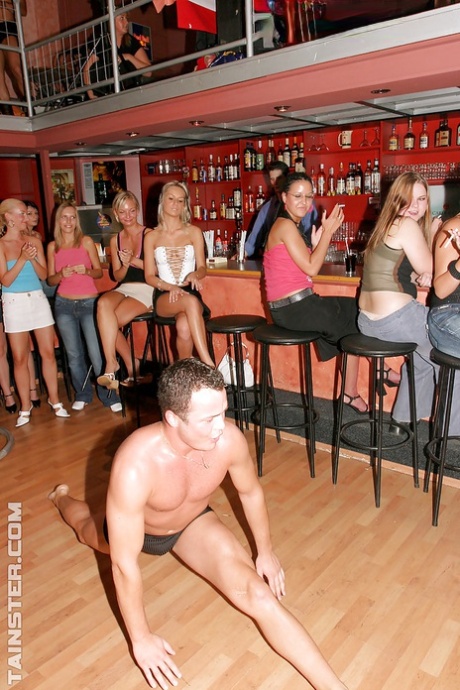 At a party, attractive women give male strippers a blowjob.